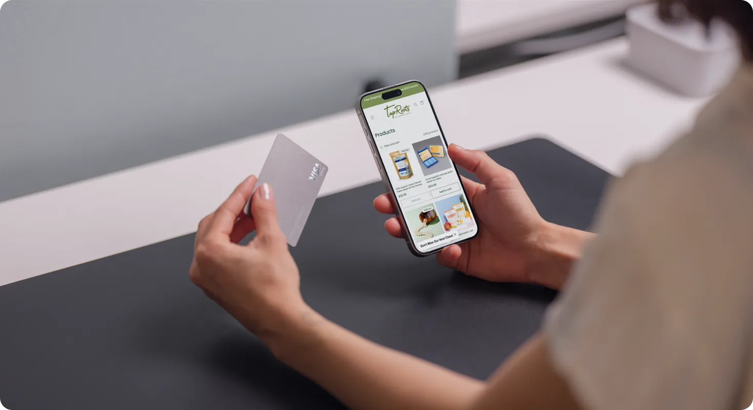 Person holding phone and card for mobile shopping